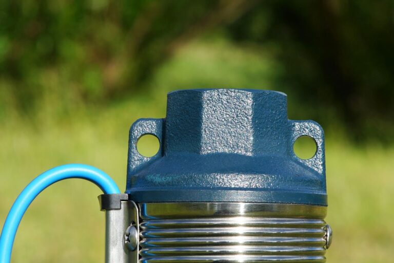 Downhole pump close-up on a bright background. Well pump with blue cable. The top of the well pump.